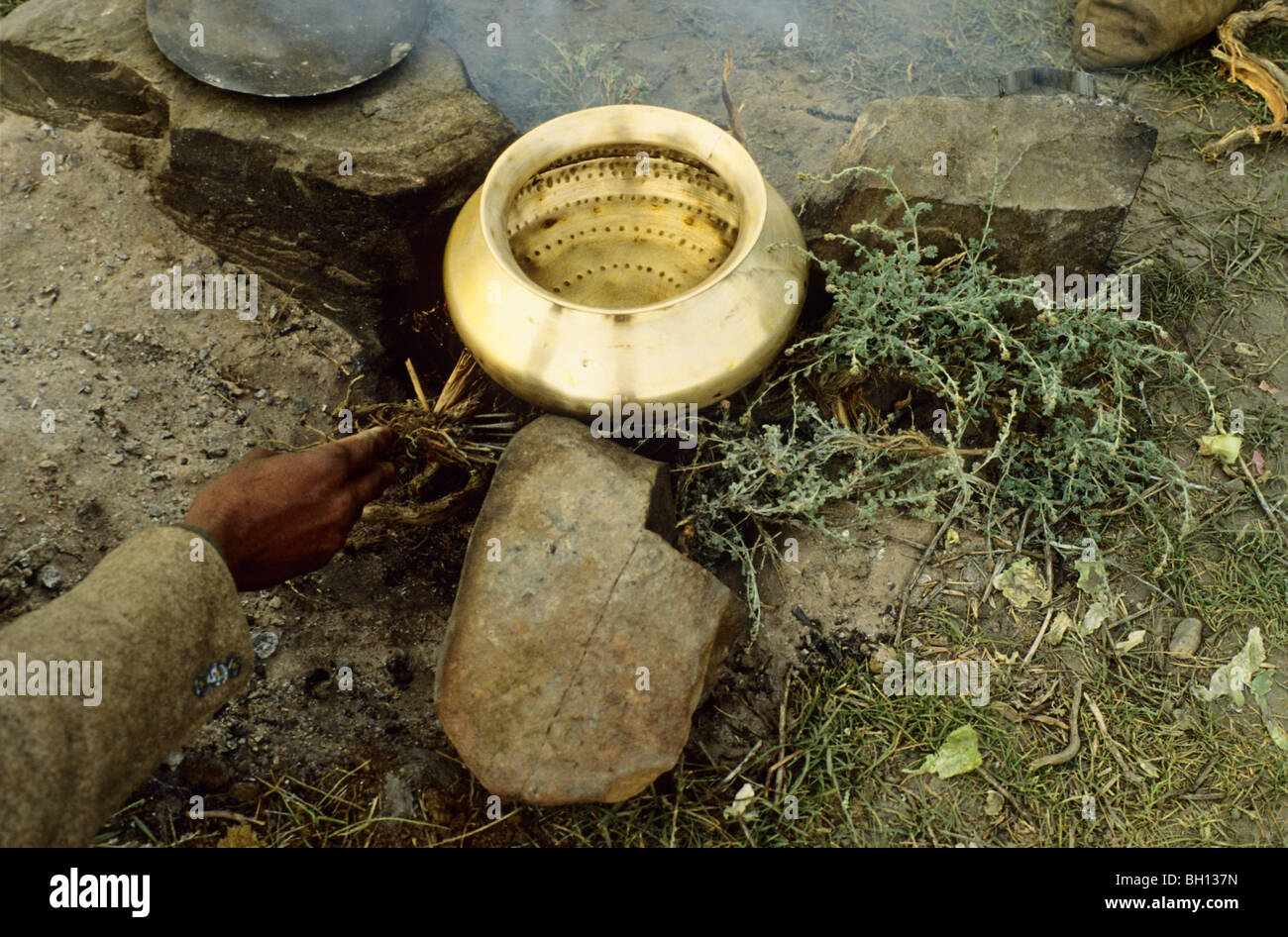 Shepherd in Northern India preparing hot water on his campfire Stock Photo