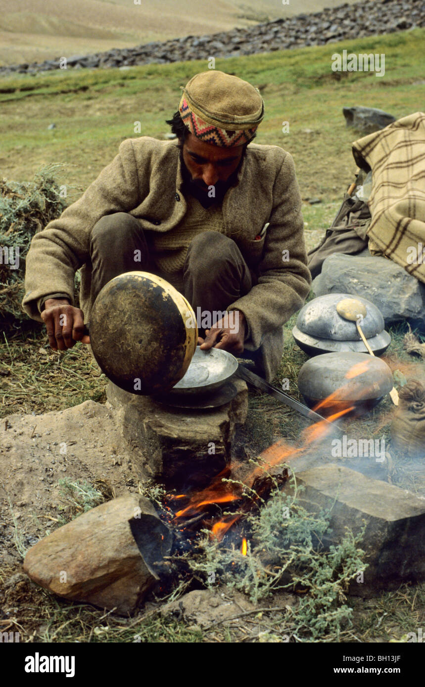 Shepherd in Northern India preparing food at his campfire Stock Photo
