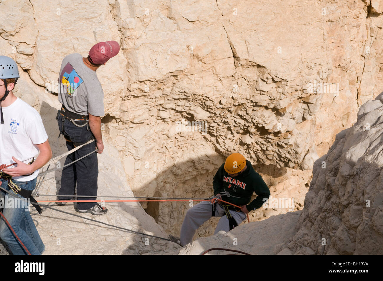Israel, Dead Sea, Qumran, Group rappeling down a dry waterfall of the Qumran river Stock Photo