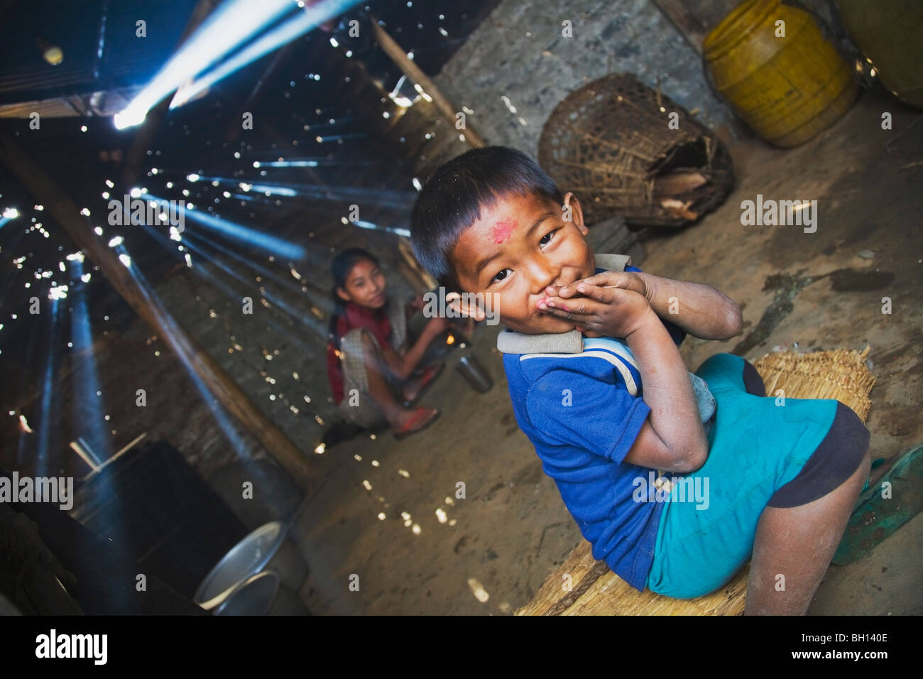 Children in smoky cook shack, Pokhara, Nepal Stock Photo