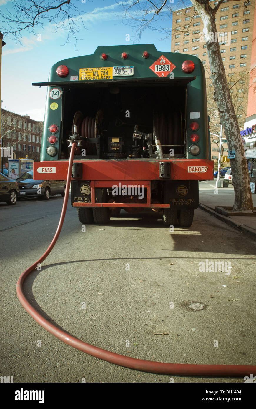 A fuel oil delivery truck arrives with a delivery of heating oil to an apartment building in the Harlem neighborhood of New York Stock Photo