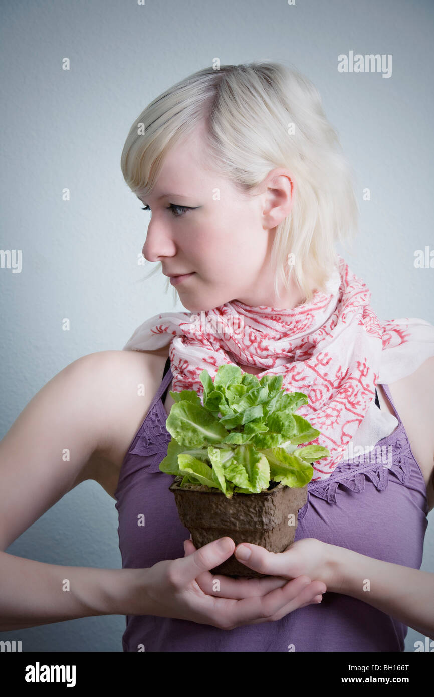 Young woman holding potted plant Stock Photo - Alamy