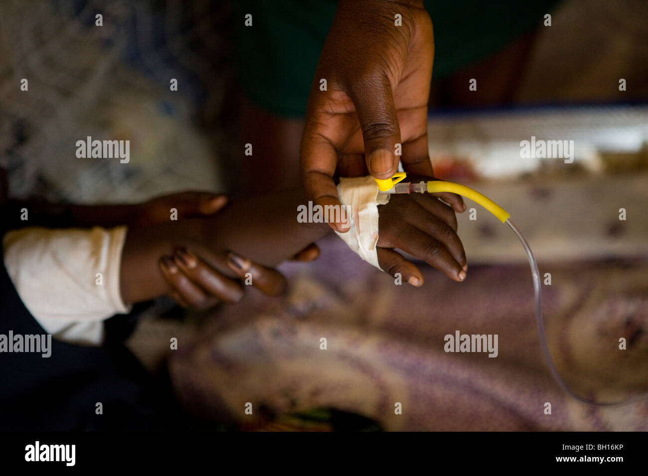 Young child on an intravenous drip receiving care in a health clinic Stock Photo
