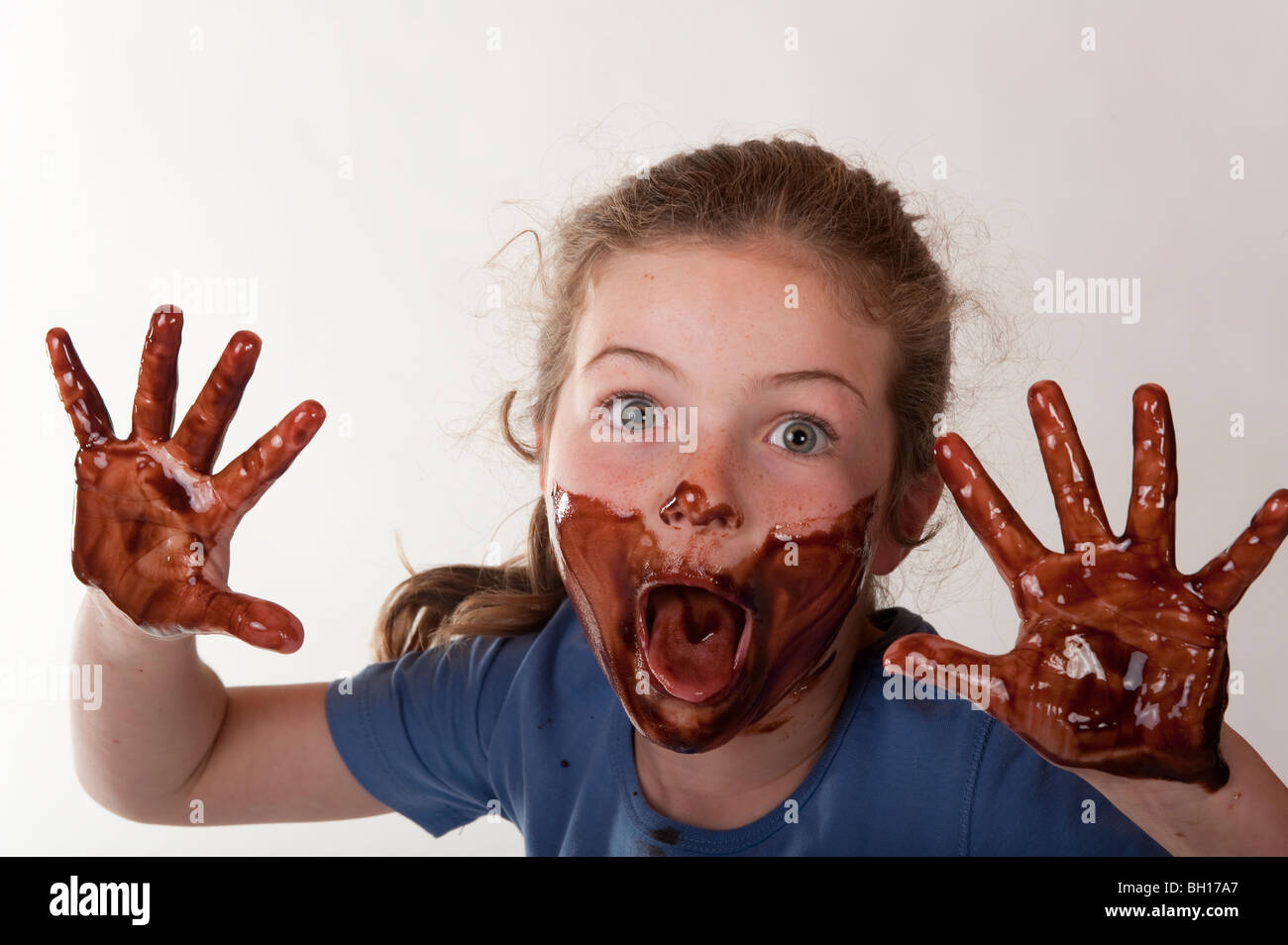 little girl smiling through chocolate covered face Stock Photo