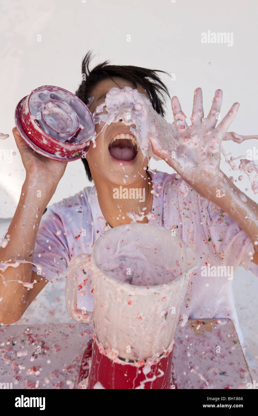 boy getting splashed by out of control overflowing blender Stock Photo