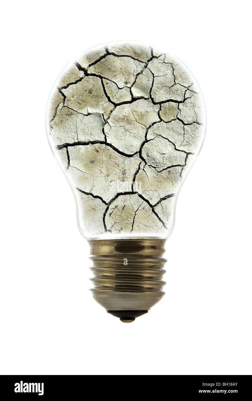 Cracked earth by drought inside incandescent lamp / bulb against white background Stock Photo