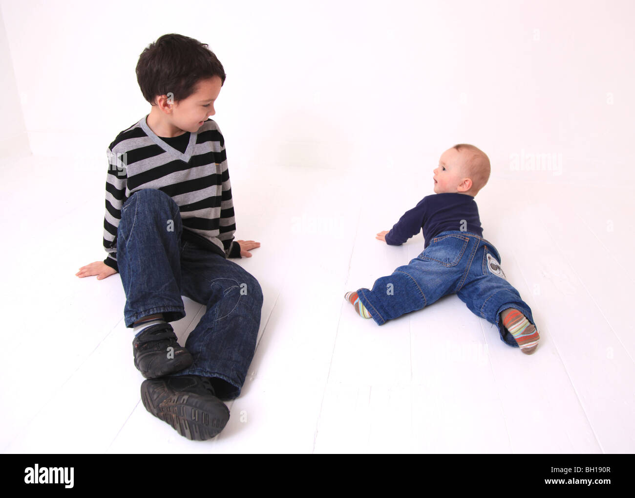Young brothers lying on floor Stock Photo Alamy