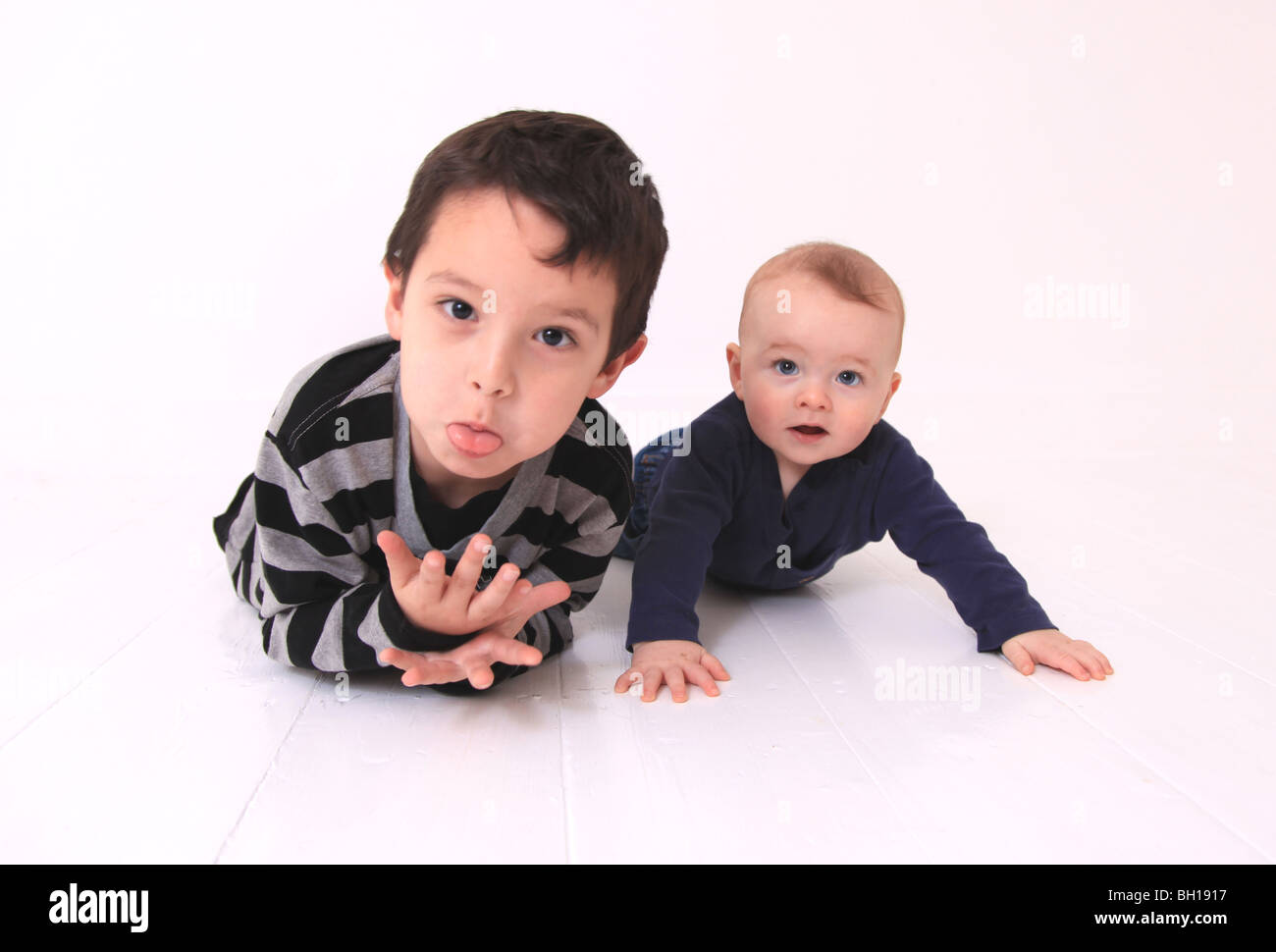 Young brothers lying on floor Stock Photo Alamy
