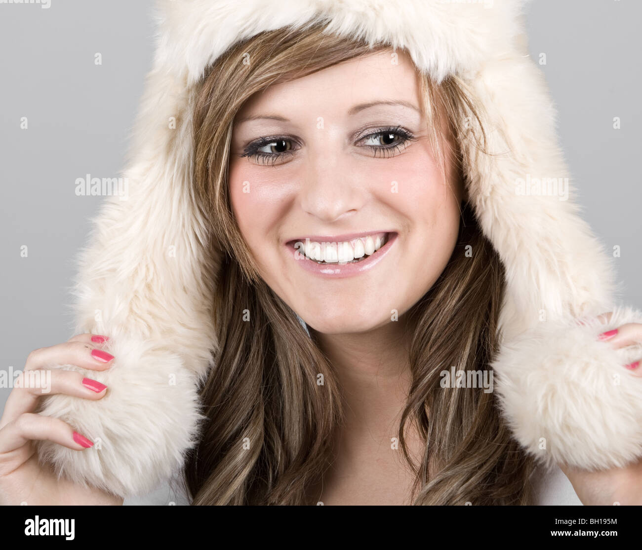 Beautiful Teenage Girl in Winter Hat against Grey Background Stock