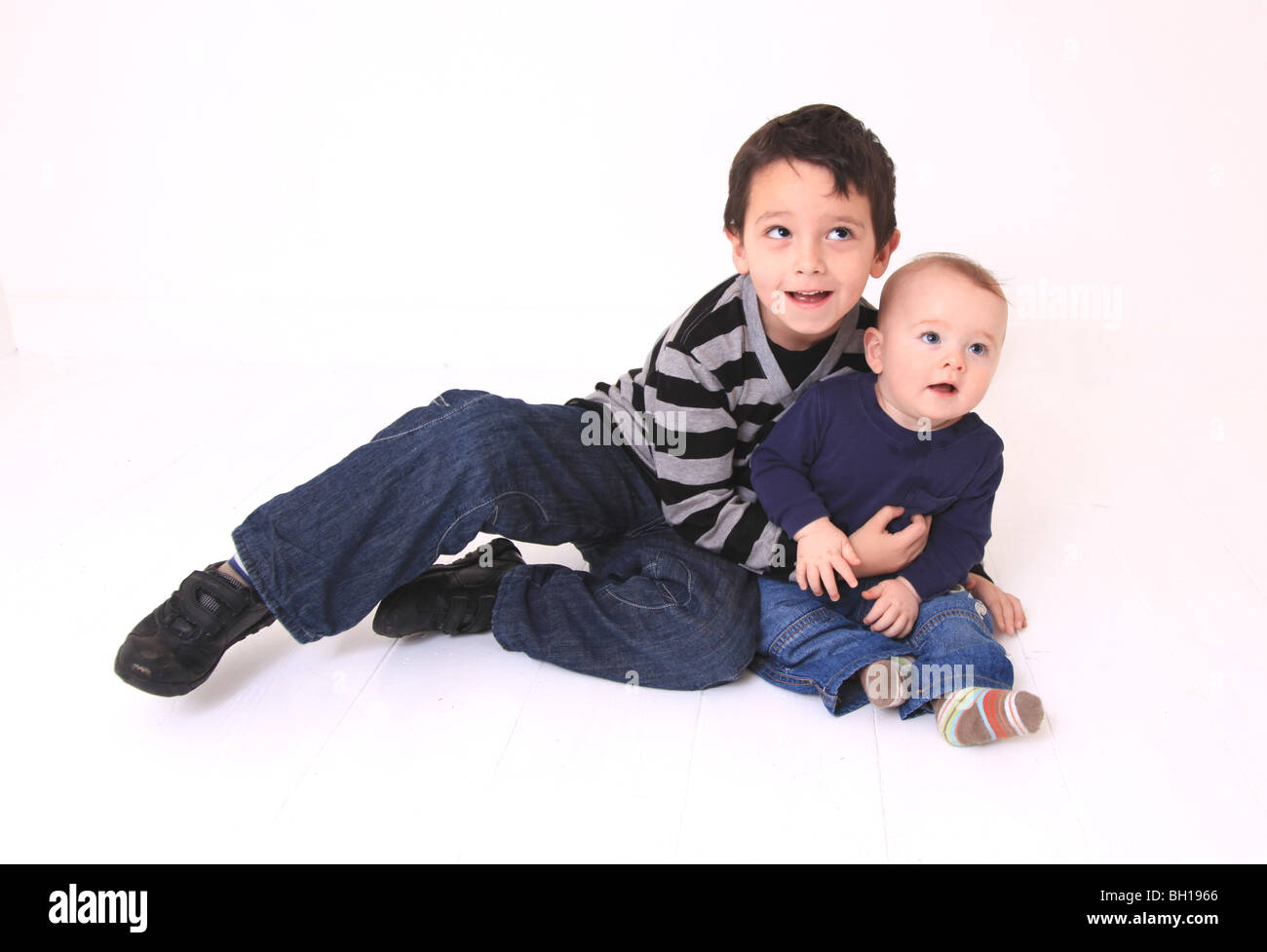 Young brothers lying on floor Stock Photo Alamy