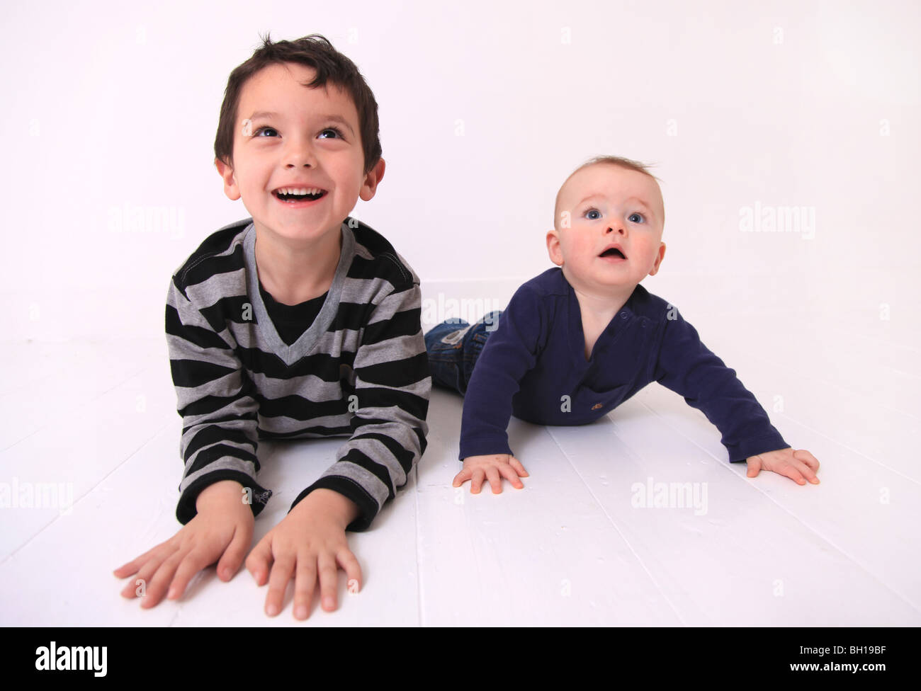 Young brothers lying on floor Stock Photo Alamy