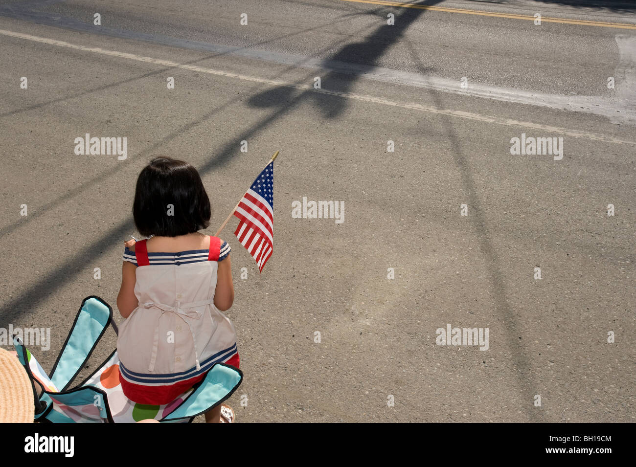Girl holding American flag during 4th of July parade Stock Photo - Alamy