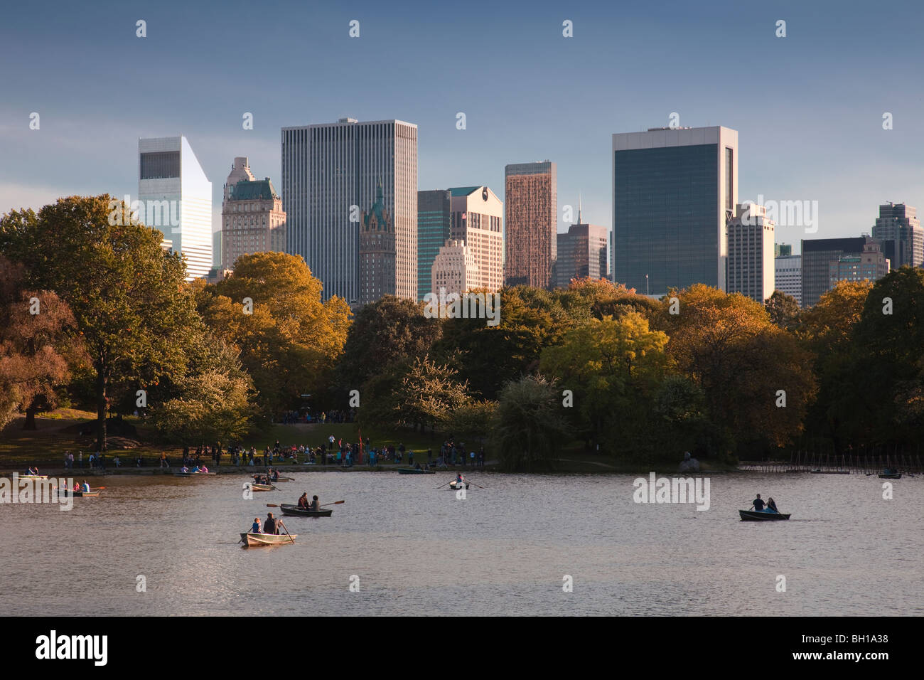 Fall view of boaters on The Lake in Central Park with Manhattan skyline. Stock Photo