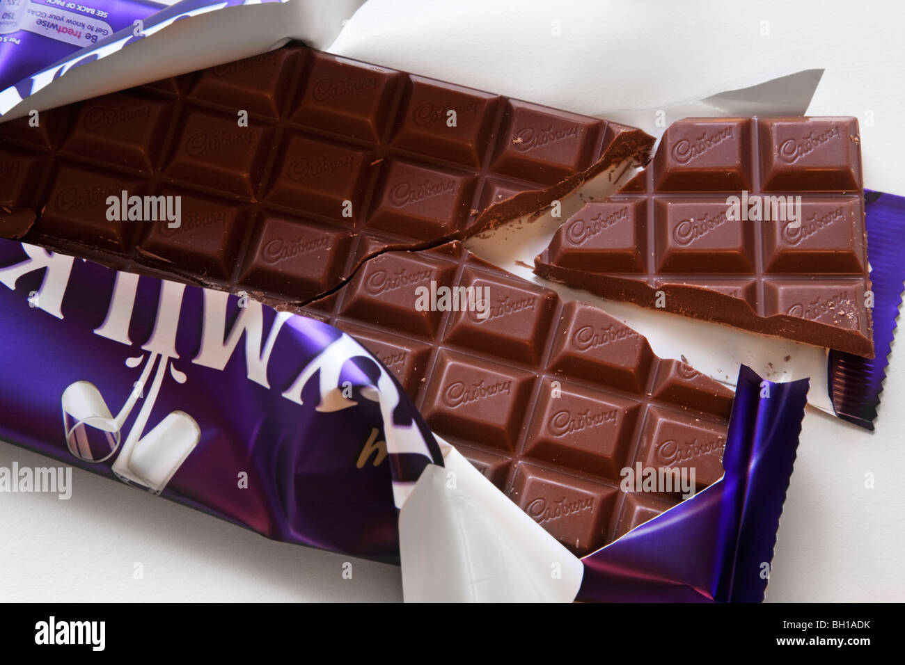 An opened and broken 230g bar of Cadbury's Dairy Milk chocolate. Stock Photo