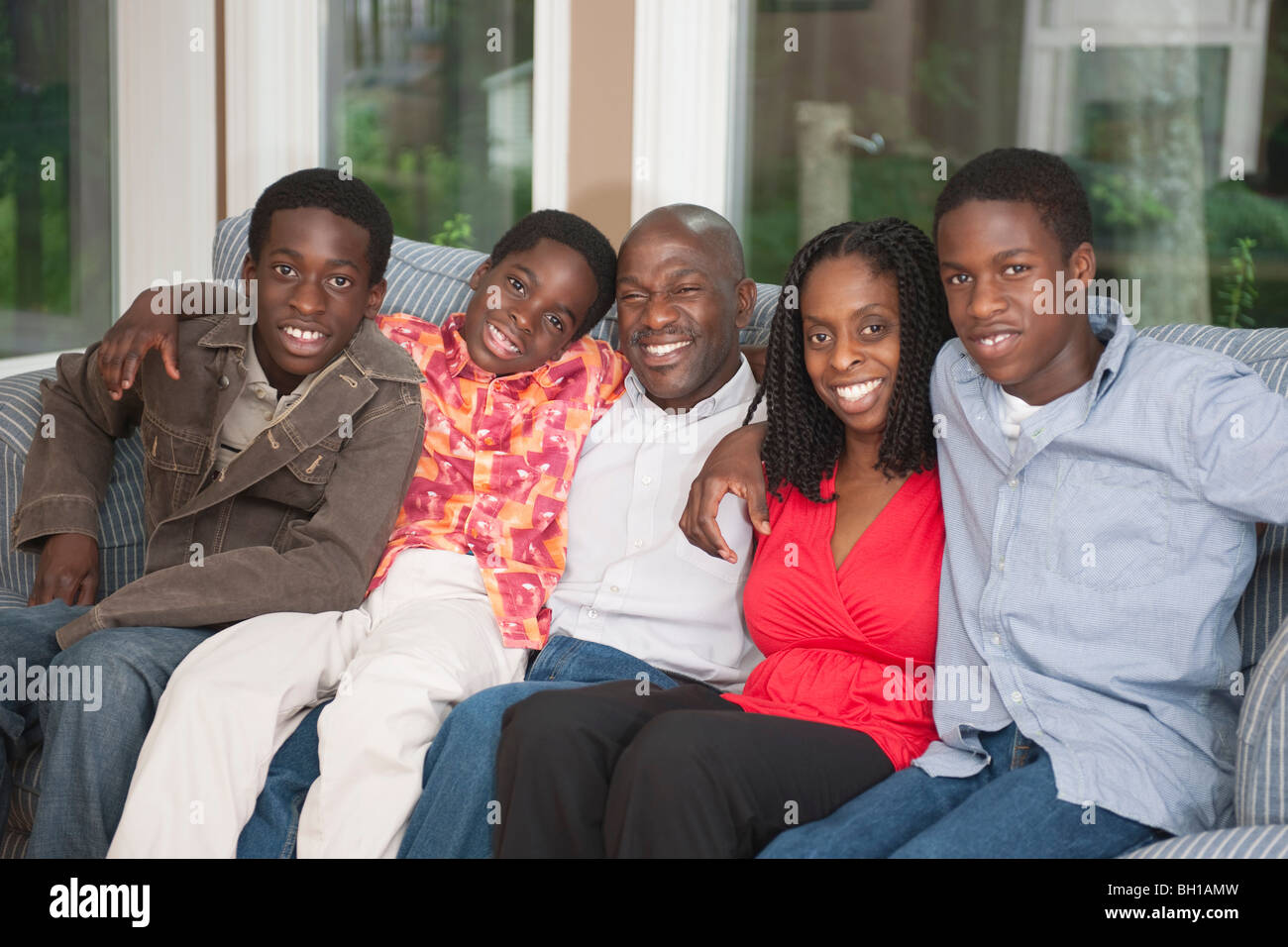 Happy African American family together on the couch Stock Photo