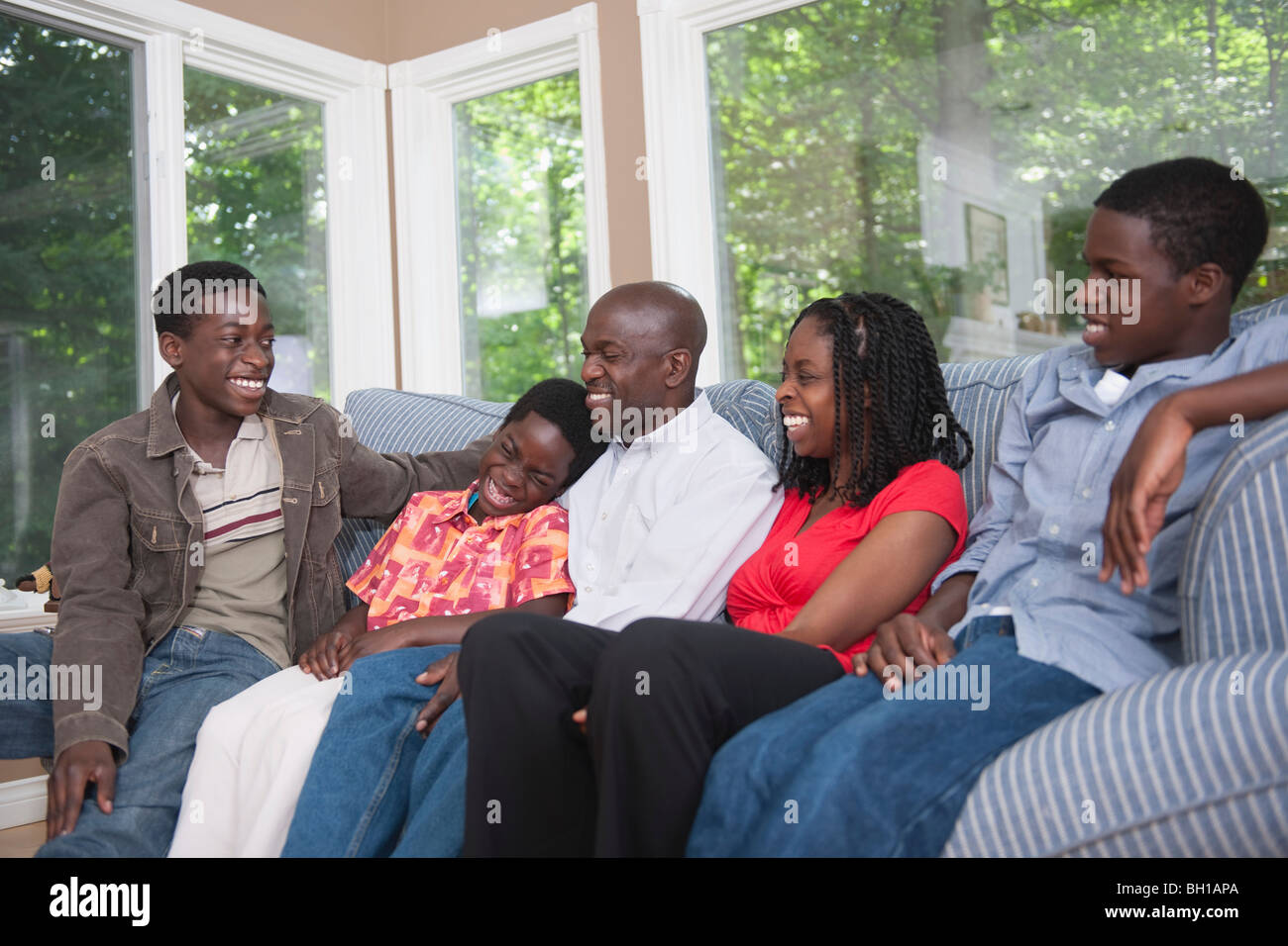 Happy African American family together on the couch Stock Photo