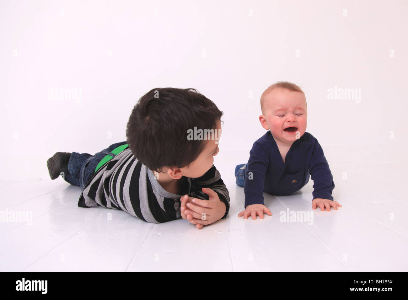 Young brothers lying on floor Stock Photo Alamy