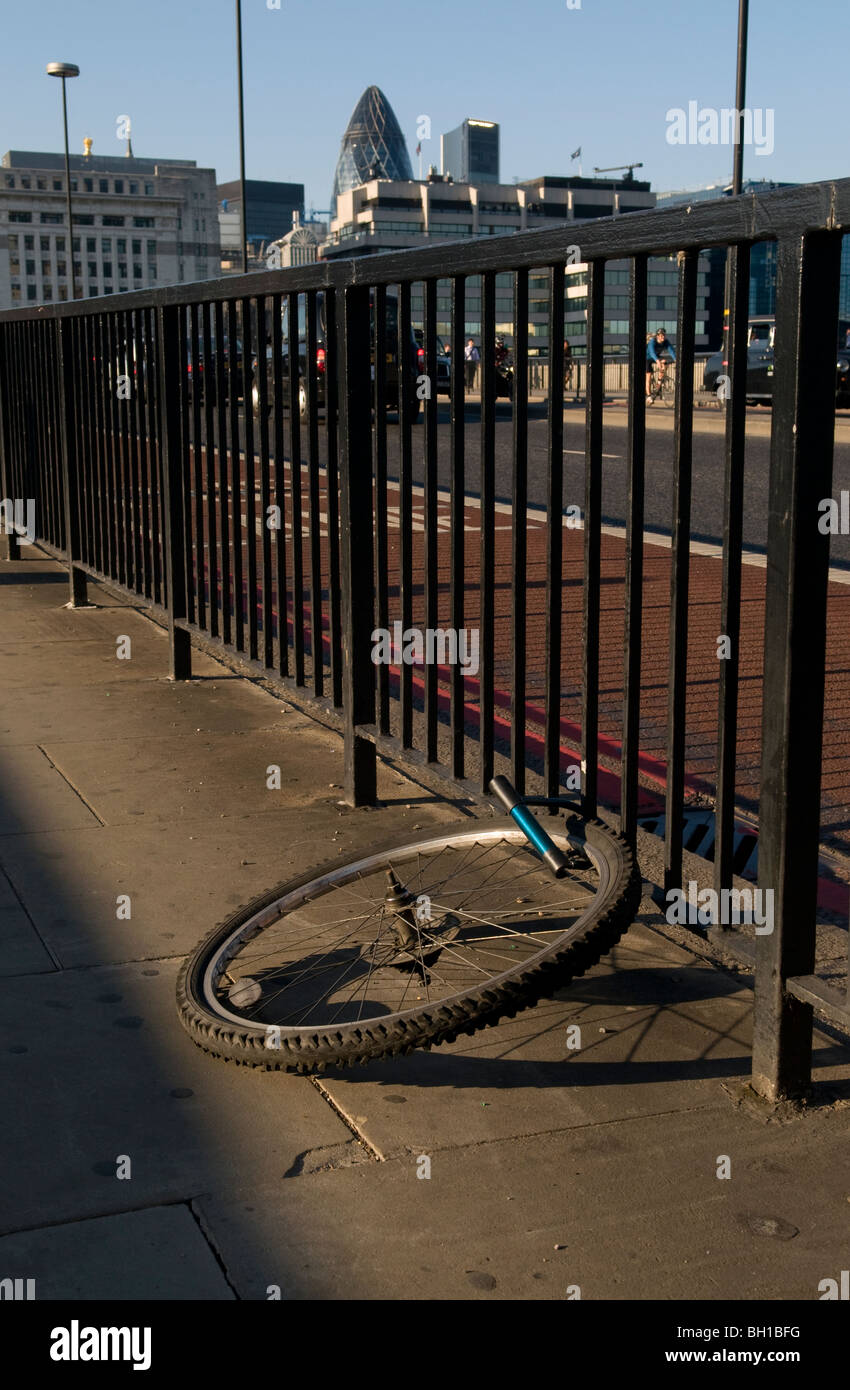 Frontwheel of a stolen bicycle, padlocked on to a railing on London
