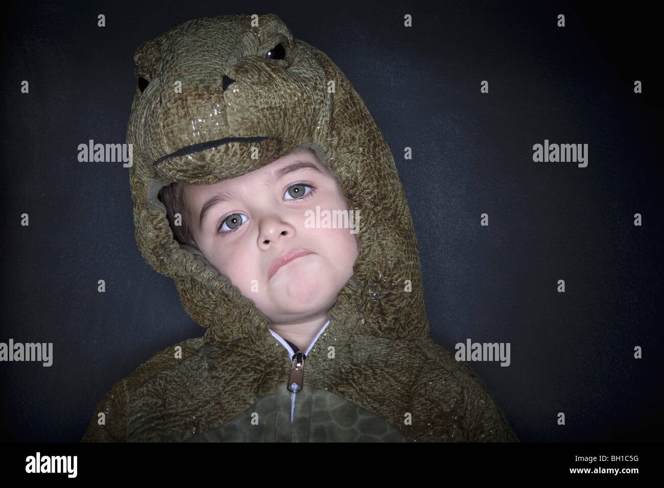 Toddler in a reptile costume Stock Photo