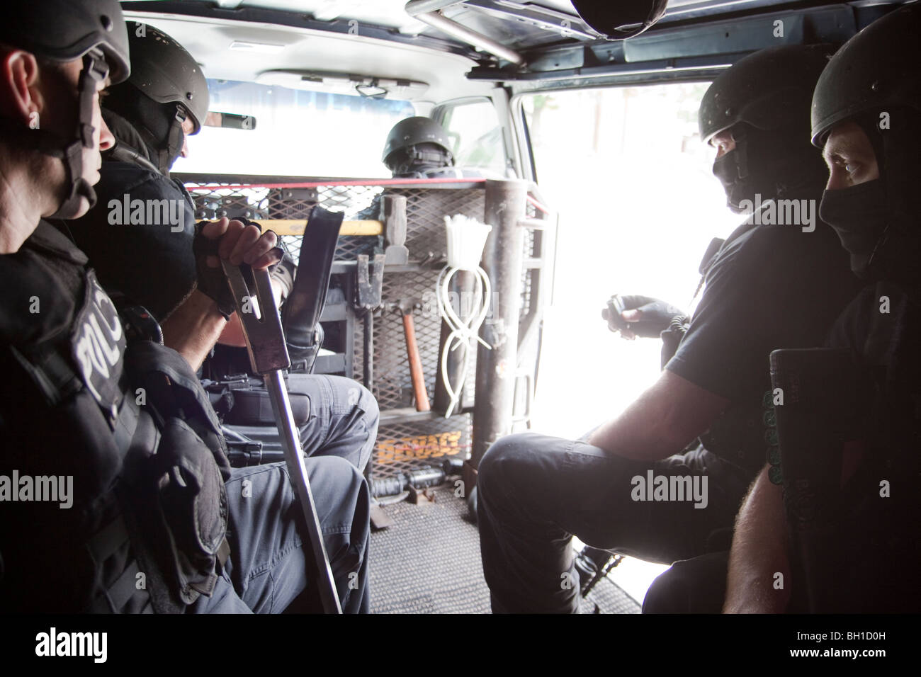 Police officers from tactical squad getting ready to serve high-risk drug related search warrant. Kansas City, MO, PD. Stock Photo