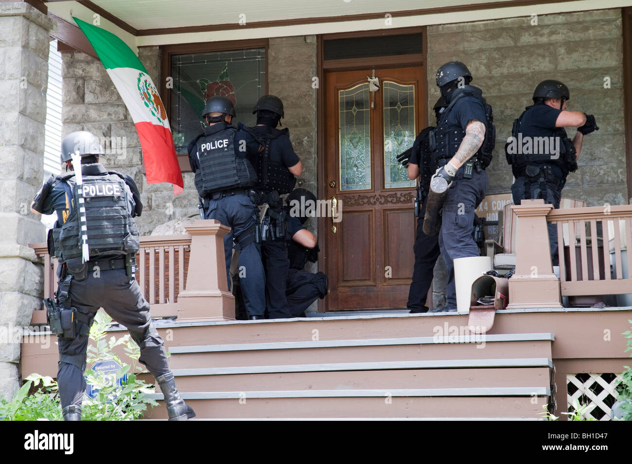 Police tactical team making entry serving a high risk drug related