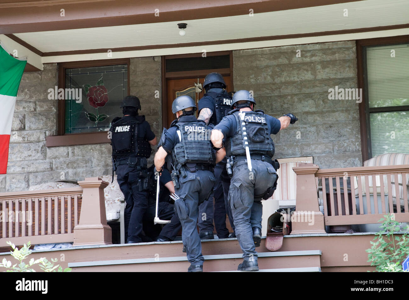 Police tactical team making entry serving a high risk drug related search warrant. Street Narcotics Unit, Kansas City, MO, PD. Stock Photo