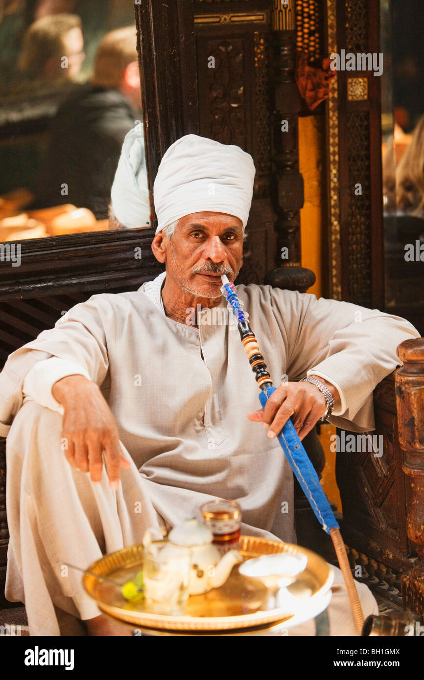 Mature man smoking a waterpipe at the Cafe Fishawi in Khan el-Khalili bazaar, Cairo, Egypt, Africa Stock Photo