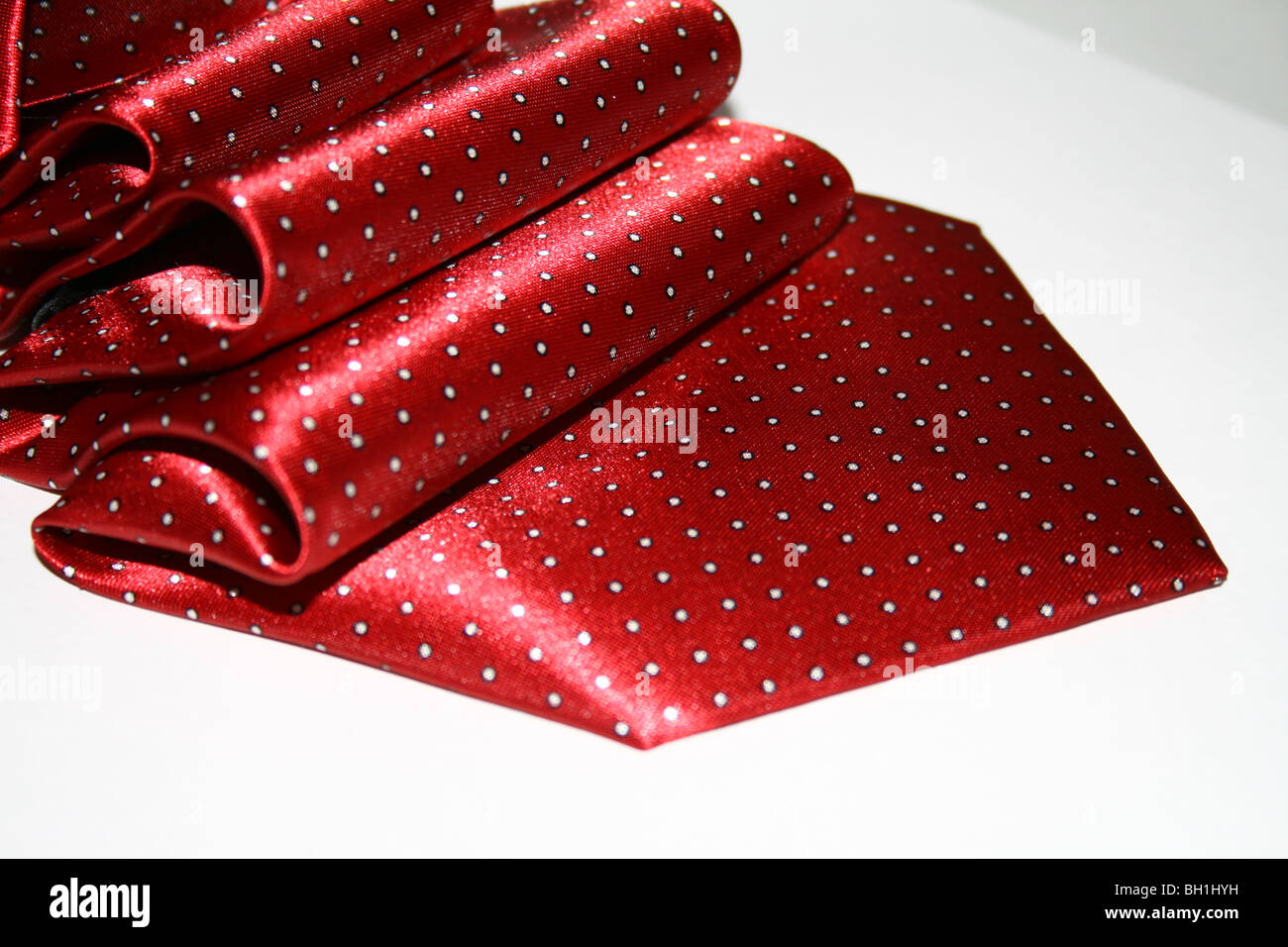 Elegant silk red man necktie with the white dots Stock Photo