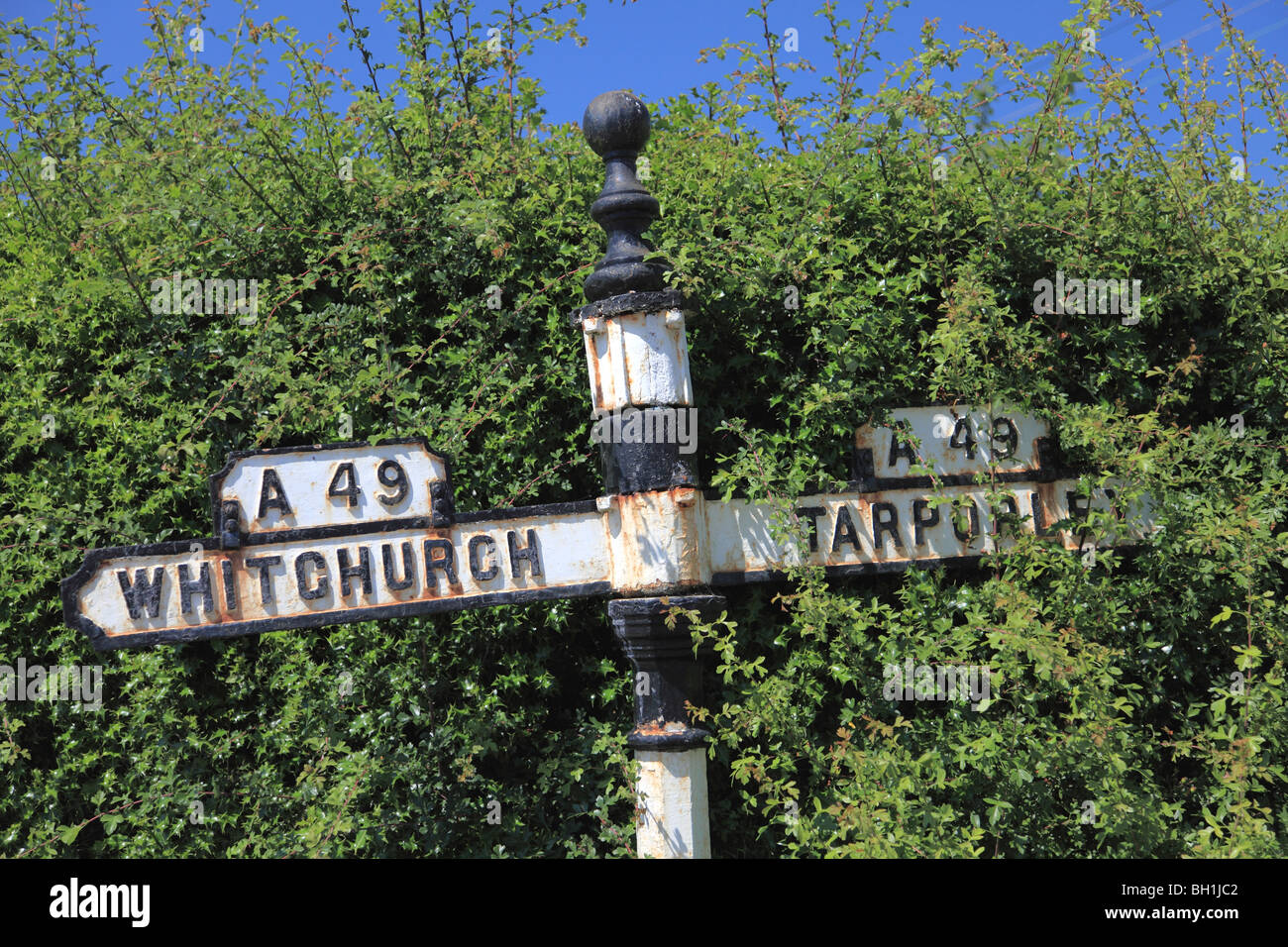 Old A49 road sign in the centre of the village of Bunbury, Cheshire; Whitchurch to the south, Tarporley to the north. Stock Photo