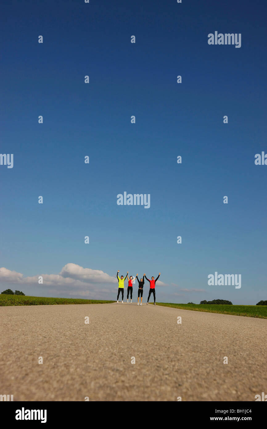 Runners with arms up, Munsing, Bavaria, Germany Stock Photo