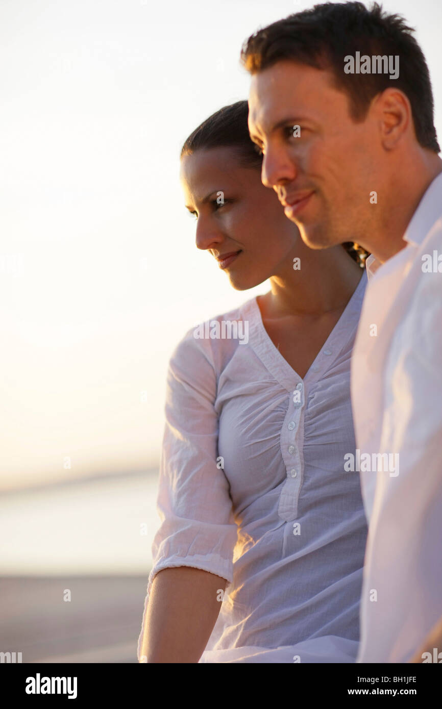 Mid adult couple in sunset, Ambach, Lake Starnberg, Bavaria, Germany Stock Photo