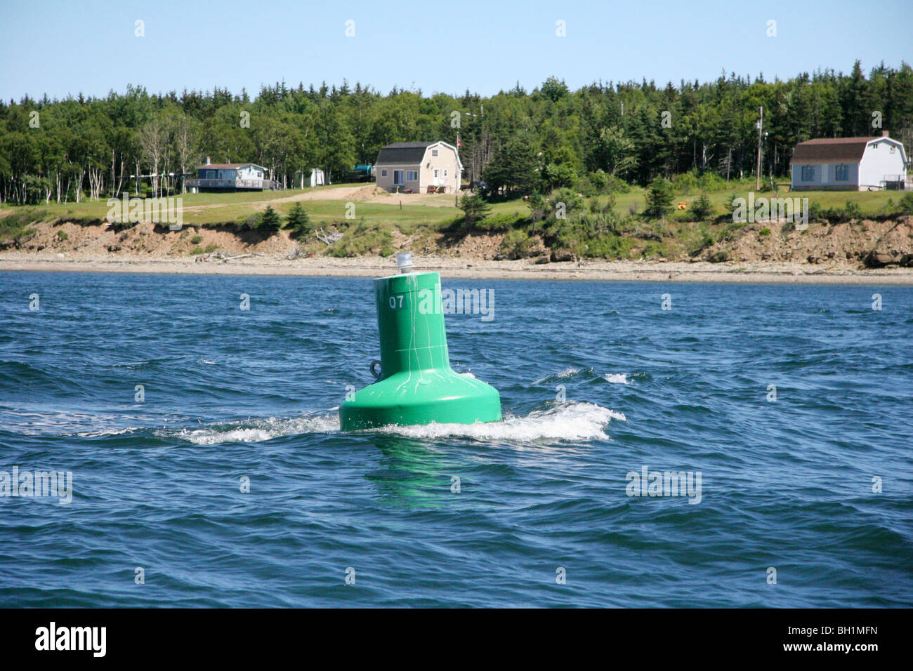 A Strong current races past a navigation buoy in the entrance to the Great Bras d'Or Channel, Nova Scotia Stock Photo