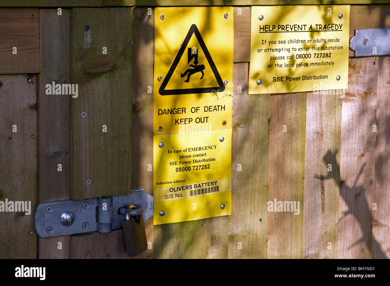Danger warning notices on the fence of an electricity substation. Stock Photo