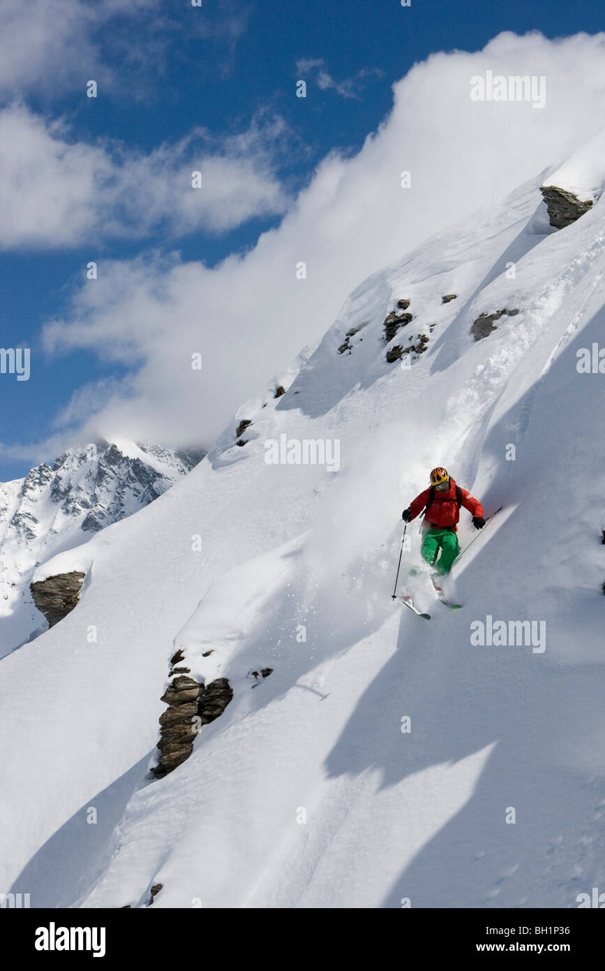 Zinal, Domaine de Freeride, A young man, a freerider sking down a steep slope in powder snow, Valais, Switzerland, Alps, MR Stock Photo