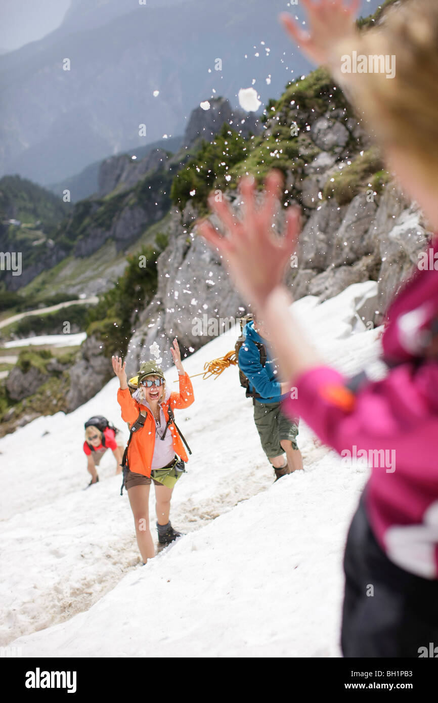 Young people snowball fighting, Werdenfelser Land, Bavaria, Germany Stock Photo