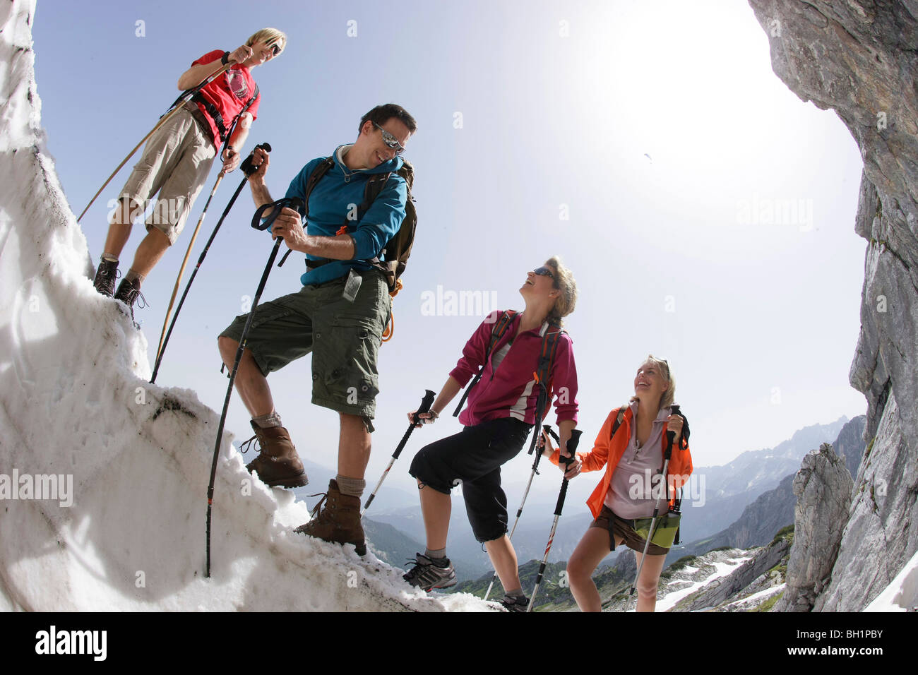 Hikers on cornice, Werdenfelser Land, Bavaria, Germany Stock Photo