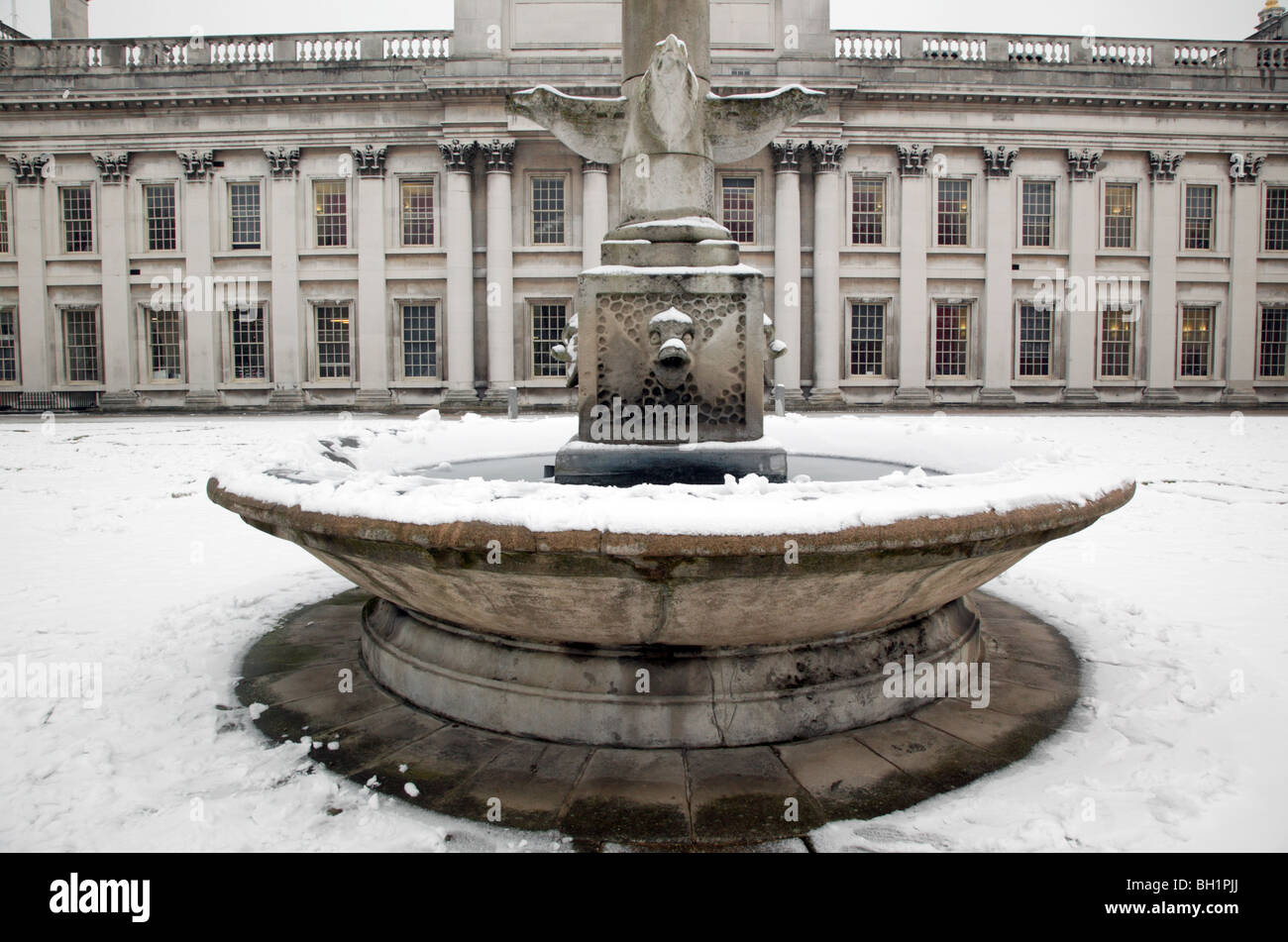 Winter scene of the frozen fountain in front of the facade of the King Charles Block of Old Royal Naval College Greenwich Stock Photo