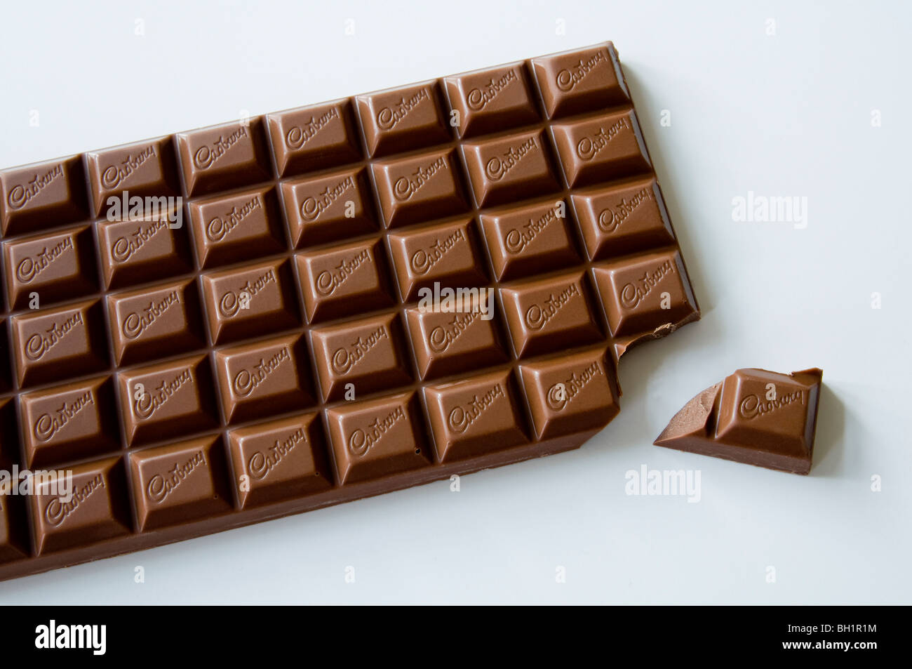 Large bar of Cadbury's chocolate with one piece broken off ! Stock Photo