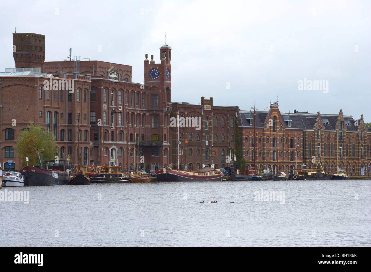 Brick-lined buildings along the river Zaan at Wormerveer, Netherlands, Europe Stock Photo