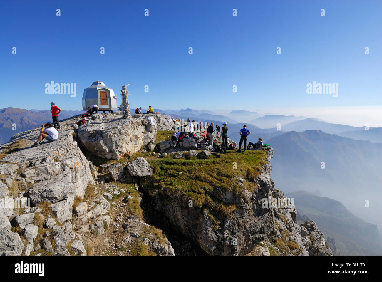 Group of hikers on summit of Grigne, Bergamo Alps, Como, Lombardy, Italy Stock Photo