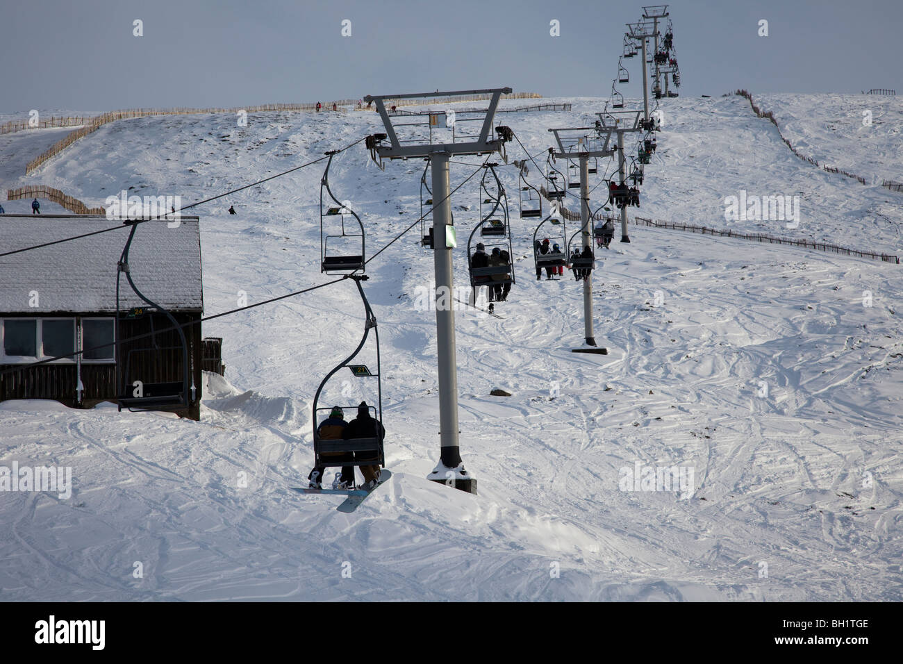 Skiers on chairlift at Glenshee ski resort in the Grampians, near Braemar, in the Cairngorms National Park,  Aberdeenshire, Scotland, UK Stock Photo