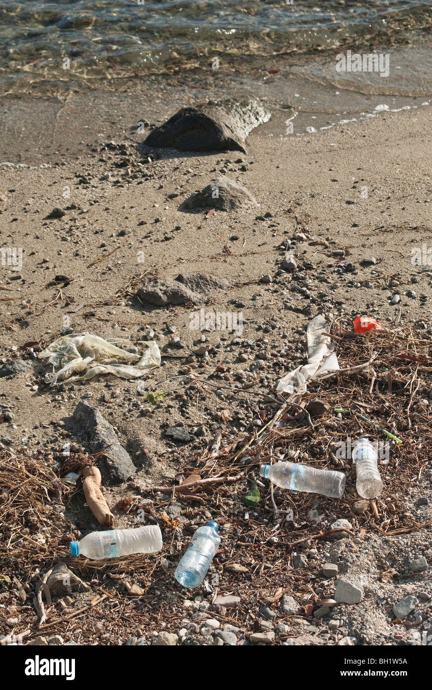 Rubbish washed up on the high tide line of on a beach in Greece Stock Photo