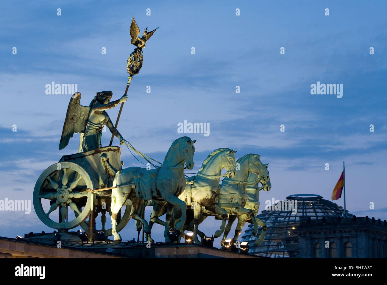 Quadriga, horse and chariot sculpture on Brandenburg Gate, in the background the Reichstag, Berlin Stock Photo