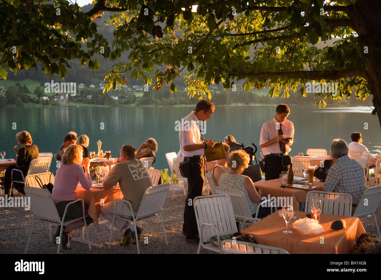 Waiters taking order for guests in the open air area of a restaurant, Lake Fuschl, Fuschl am See, Salzkammergut, Salzburg, Austr Stock Photo
