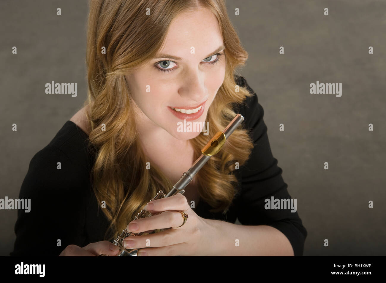 Female flautist smiles looking up at cameraq Stock Photo Alamy