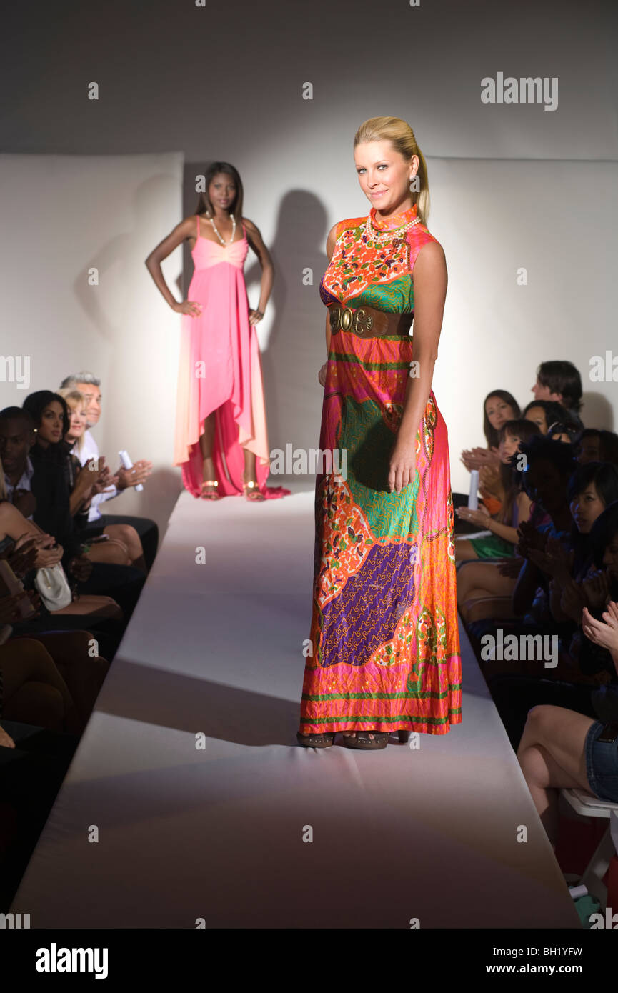 Woman in multicoloured dress on fashion catwalk Stock Photo