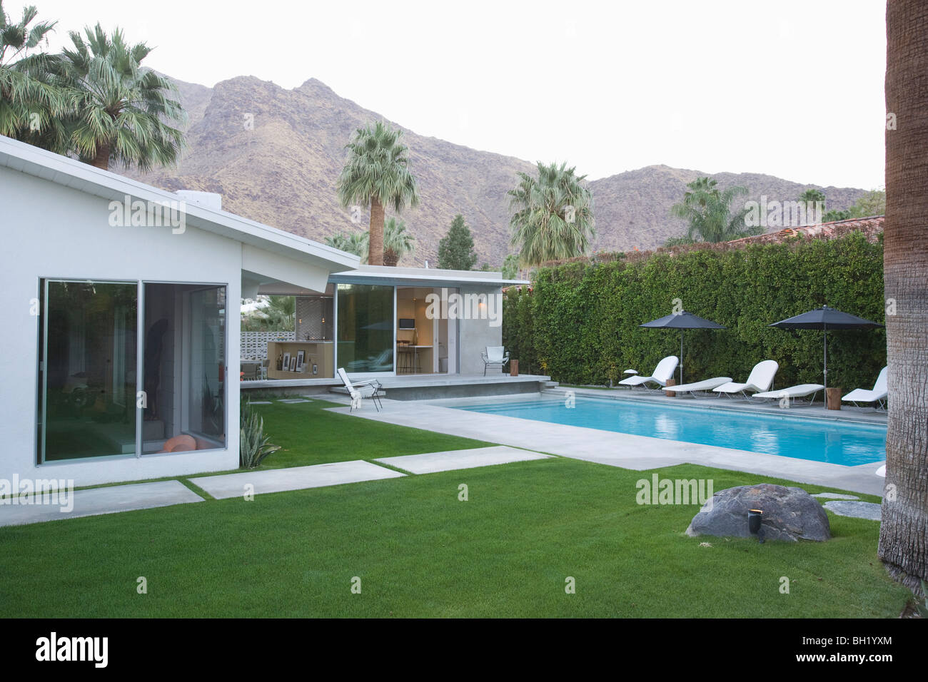 Palm Springs swimming pool and home exterior Stock Photo