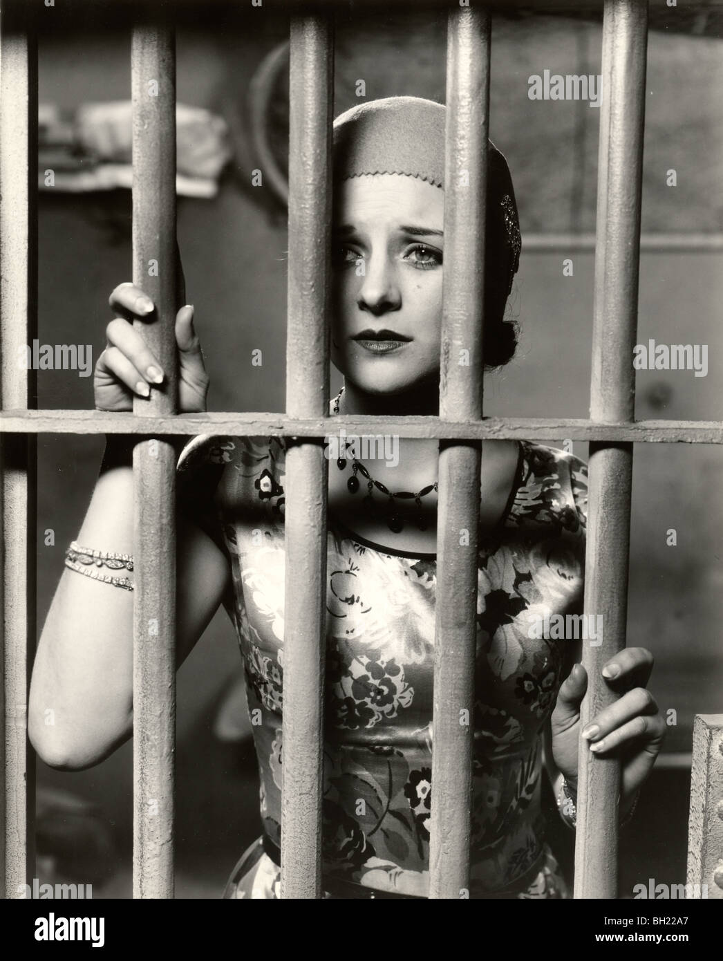 Beautiful Woman Behind Bars in Prison Stock Photo