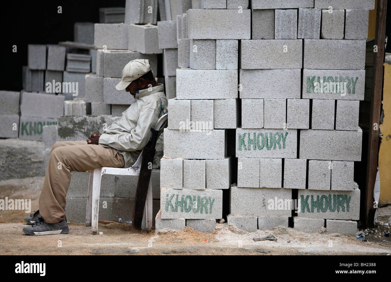 Sleeping security guard on a construction site, Barahona, Dominican Republic Stock Photo