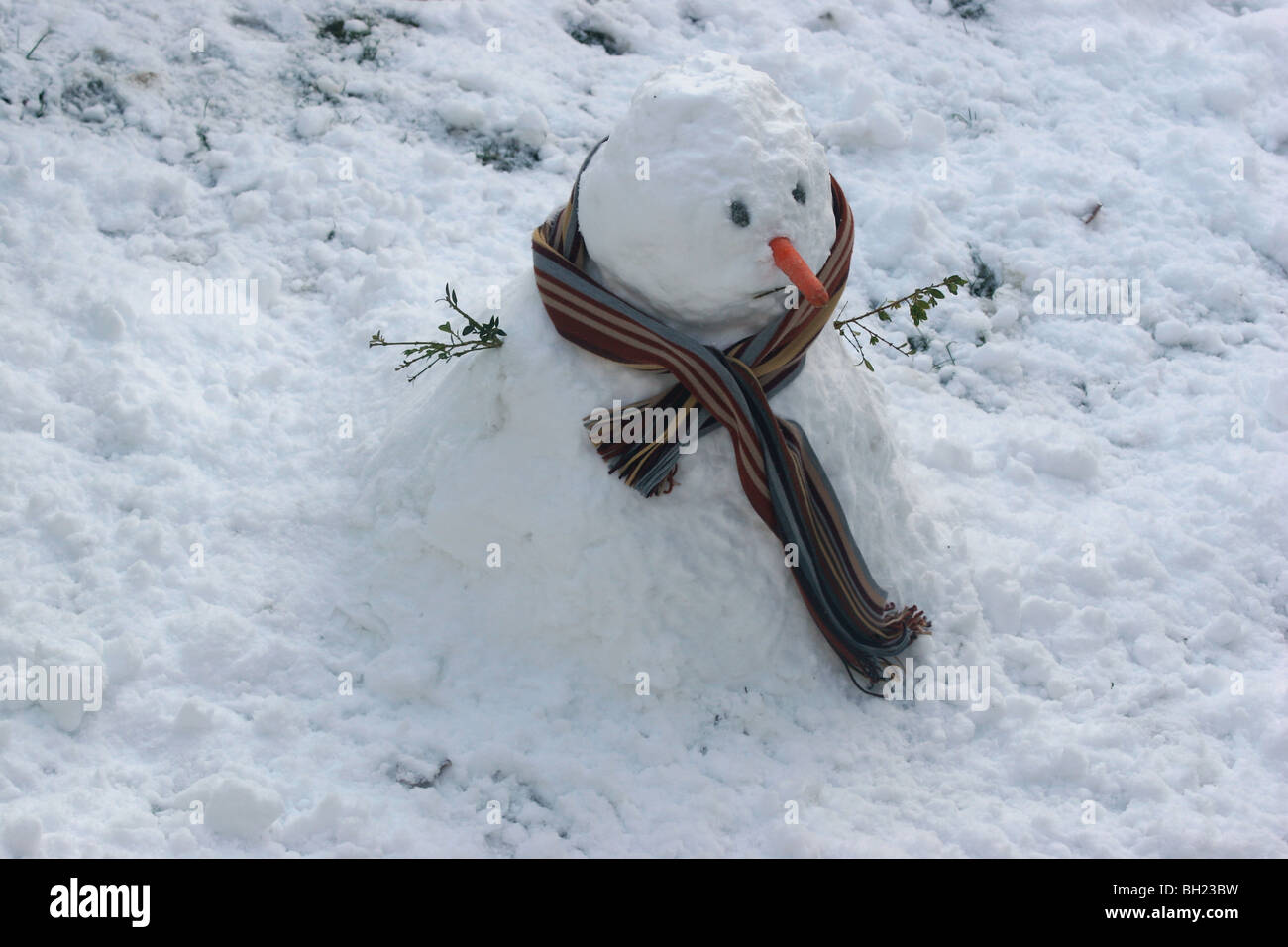 Snowman wearing s scarf Stock Photo